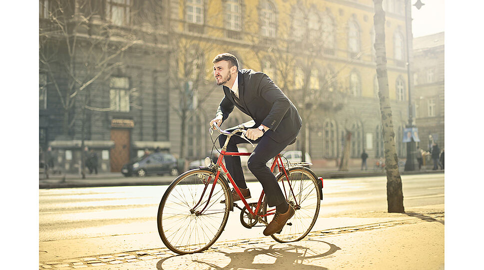 Mann fährt mit dem Rad in einer Stadt